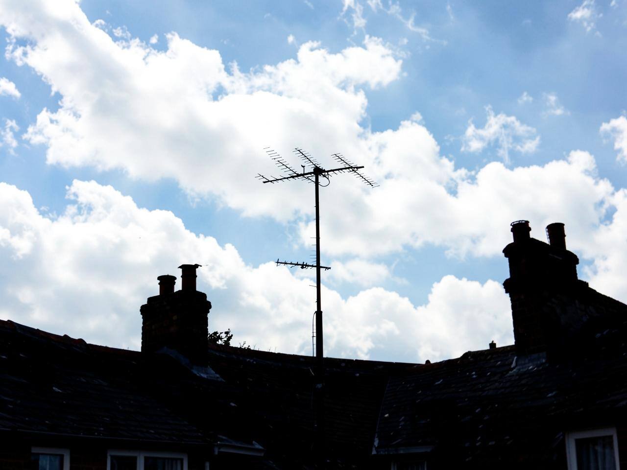 Television aerial fitted above a rooftop in Reading